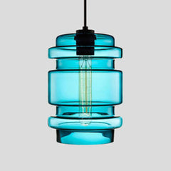 Blue ribbed glass pendant with stacked rings and a filament bulb