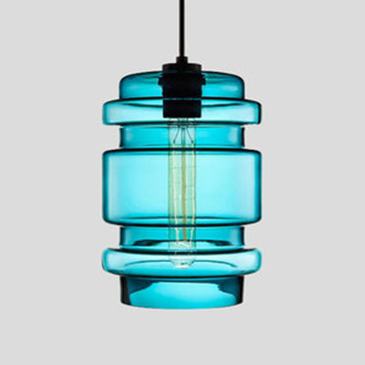 Blue ribbed glass pendant with stacked rings and a filament bulb