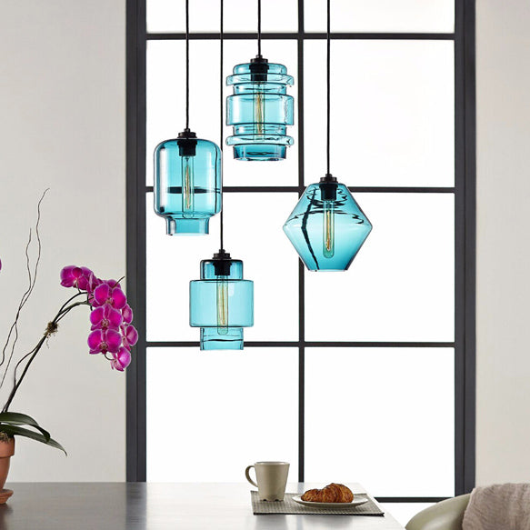 Blue glass pendants hung in a black window frame beside orchids