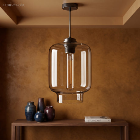 Clear ribbed glass pendant lit above a console in a brown room