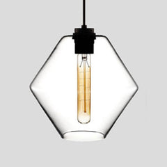 Clear faceted glass pendant with angled sides, lit against grey