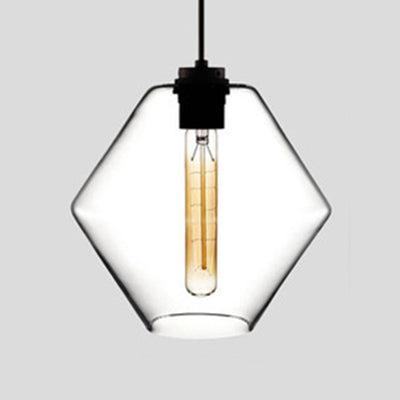 Clear faceted glass pendant with angled sides, lit against grey
