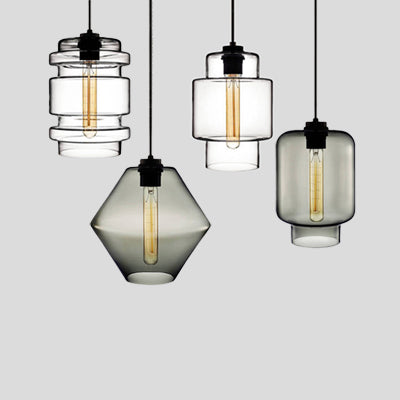 Three clear and smoke pendants hung together at staggered heights
