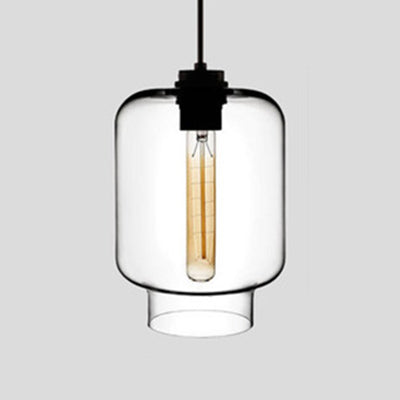 Clear tapered glass pendant with a black cap, lit against grey