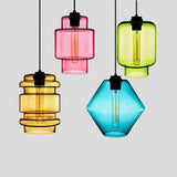 Four pendants in amber, pink, green and blue shown grouped together