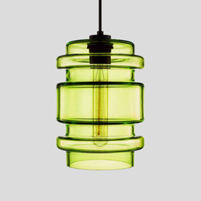 Green ribbed glass pendant with stacked rings and a filament bulb