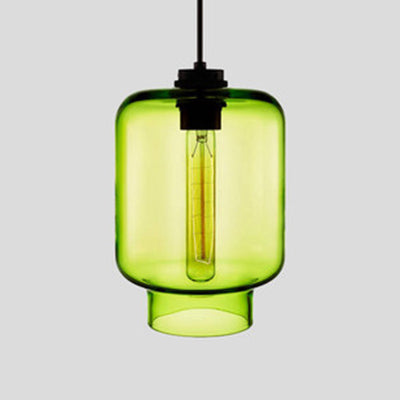 Green tapered glass pendant with a black cap and a lit filament