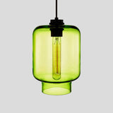 Green tapered glass pendant with a black cap and a lit filament