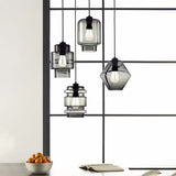 Clear and smoke pendants in mixed shapes hung in a window frame