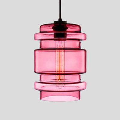 Pink ribbed glass pendant with stacked rings and a filament bulb