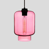 Pink tapered glass pendant with a black cap and a lit filament