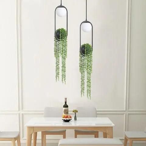 Two planter pendants hung above a small white dining table