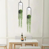 Two planter pendants hung above a small white dining table