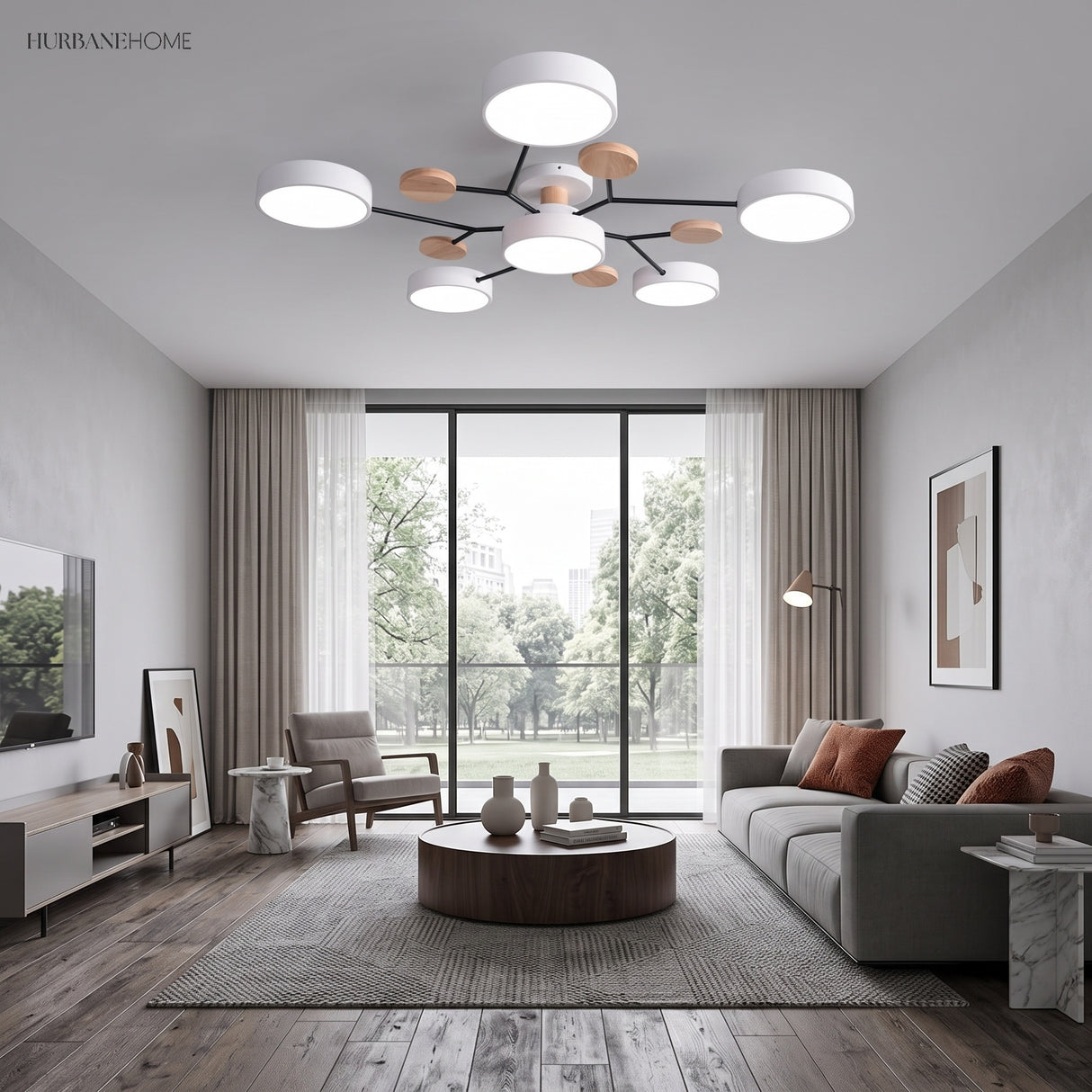 Modern circular LED ceiling light in a contemporary living room with grey sofa and floor-to-ceiling windows
