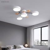 Modern circular LED ceiling light in a minimalist bedroom with grey walls and a large window