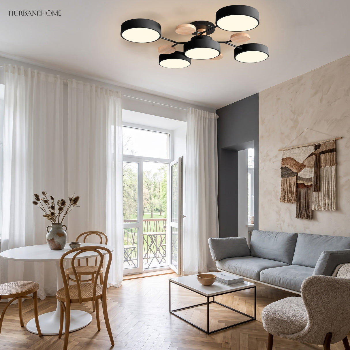 Black modern circular LED ceiling light in an open-plan dining and living space with balcony doors