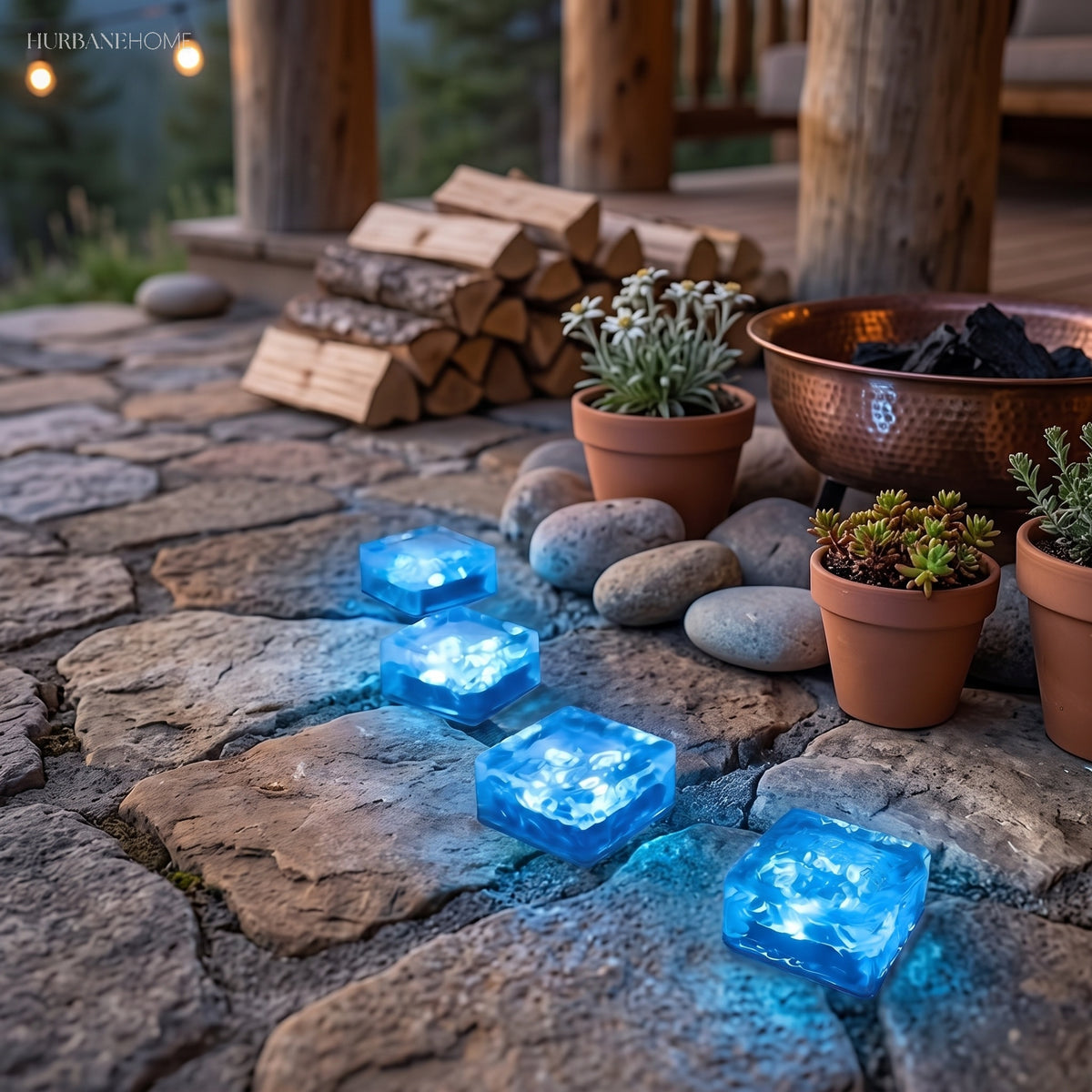 Blue glowing cube lights set into a stone patio next to a stacked log store