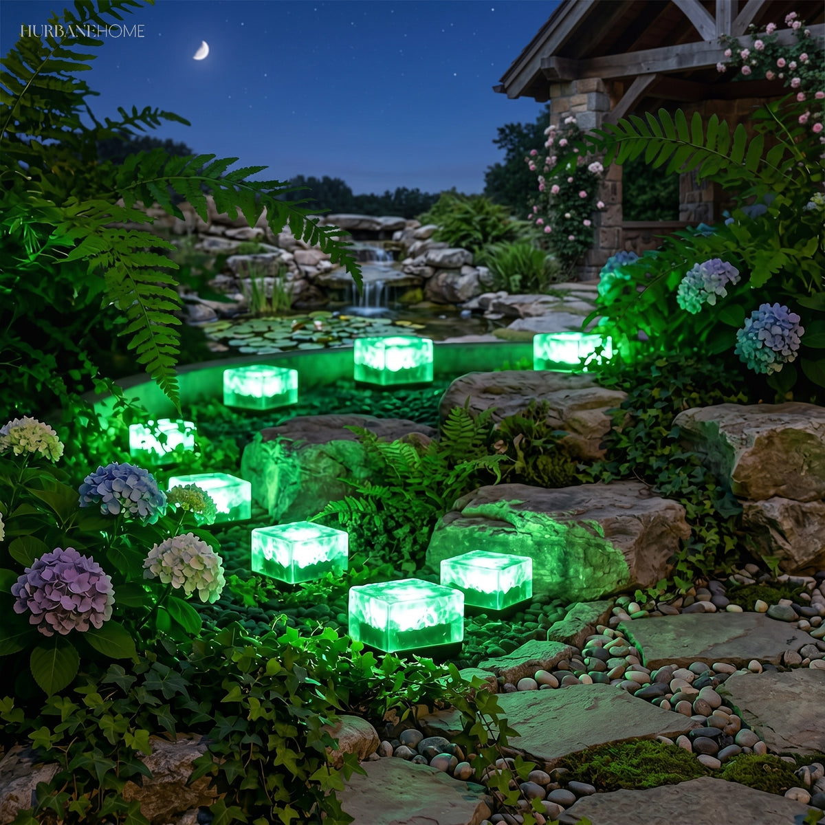 Green ice cube garden lights lining a rockery path around a lily pond at night