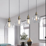 Four shade shapes hanging together in a bright open plan living room