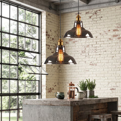 Two glass pendant lights above a concrete kitchen island beside a steel window