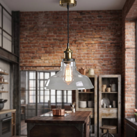 Clear glass dome pendant light hanging over a wooden table in a brick loft