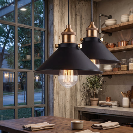Two black cone pendants lit above a kitchen worktop by a window
