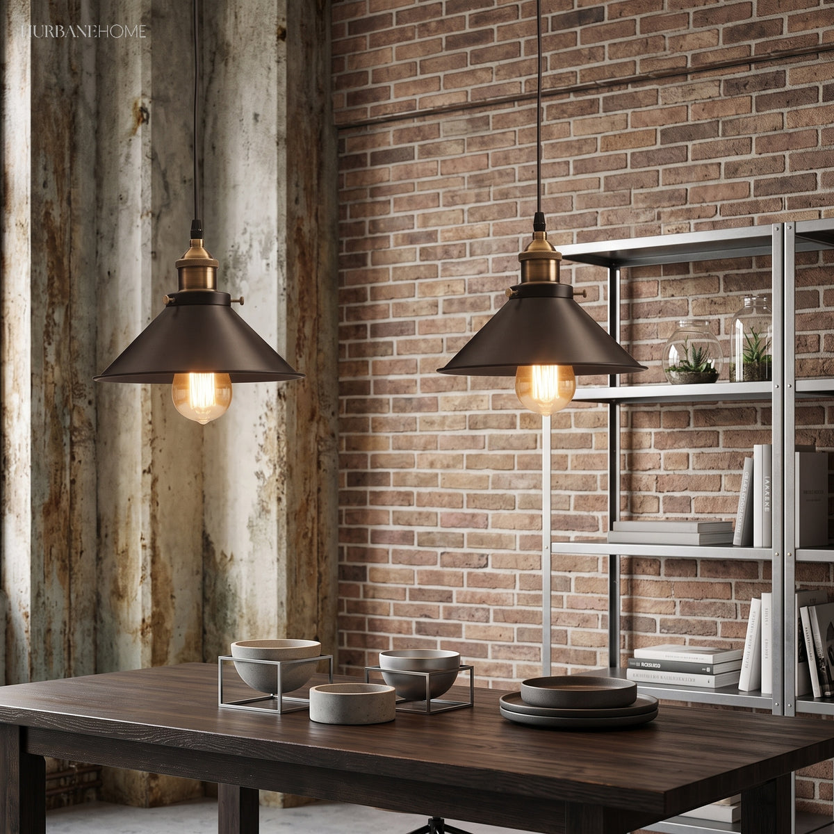 Two industrial pendants lit above a dark dining table and chairs