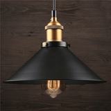 Single black cone pendant with an exposed bulb against dark timber