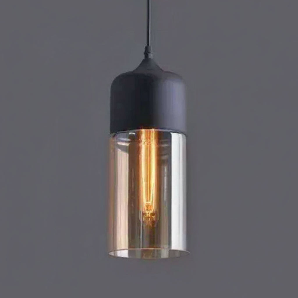 Amber cylinder shade with a black metal cap on a grey background