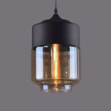 Close view of the amber drum shade lit warm on grey