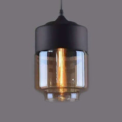 Close view of the amber drum shade lit warm on grey
