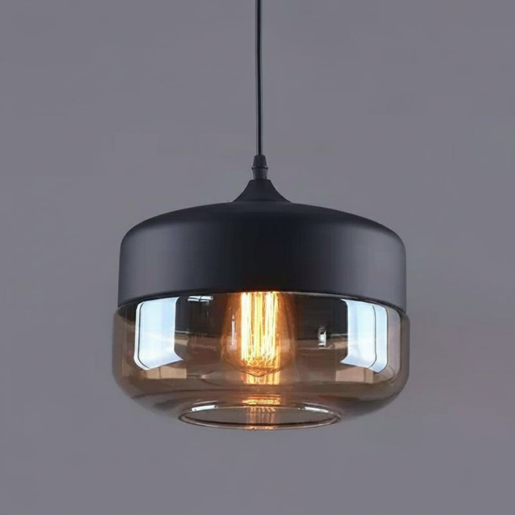 Amber drum shade with a black metal cap on a grey background