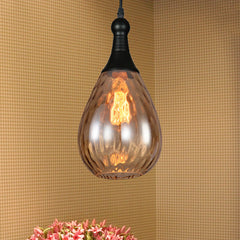 Amber teardrop pendant above pink flowers on a woven textured wall