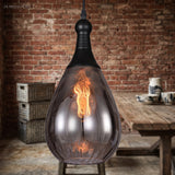 Black capped teardrop pendant lit against exposed brick and crates