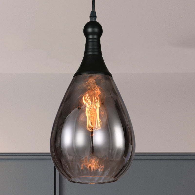 Smoke teardrop pendant lit against a grey and white painted corner