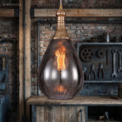 Brass capped teardrop pendant over a bench hung with hand tools