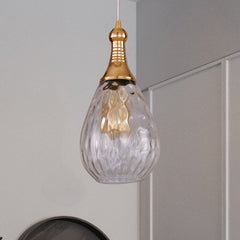 Clear teardrop pendant hanging in a grey room beside a doorway