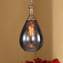 Smoke glass teardrop pendant on an ochre wall above red flowers