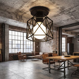Black geometric cage ceiling light in an open plan industrial room