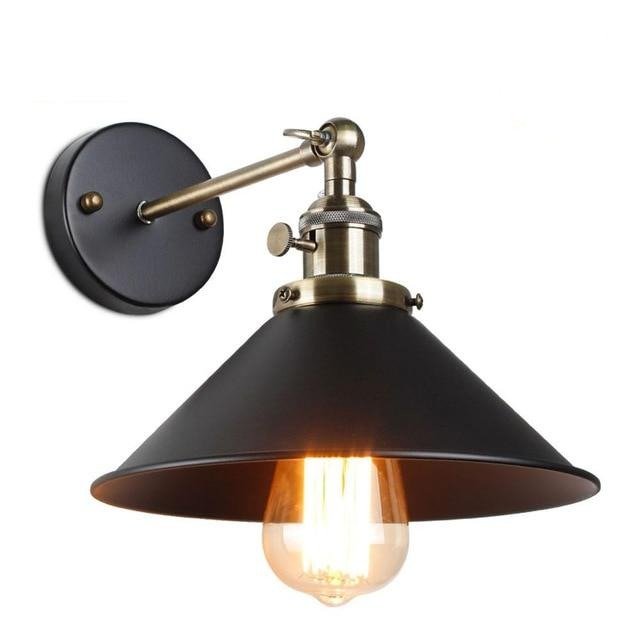 Black cone shade sconce with a polished brass socket and thumbscrews