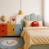 Light blue and yellow pendant in a kids bedroom beside a colour-block cabinet