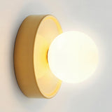Iron bodied orb wall sconce with a frosted glass globe front on