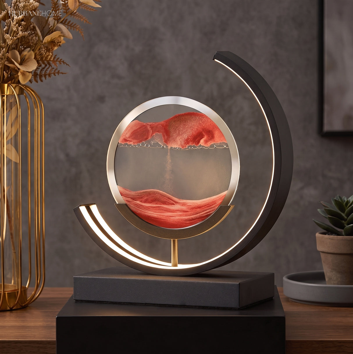 Kinetic sand lamp with curved LED light on styled console table
