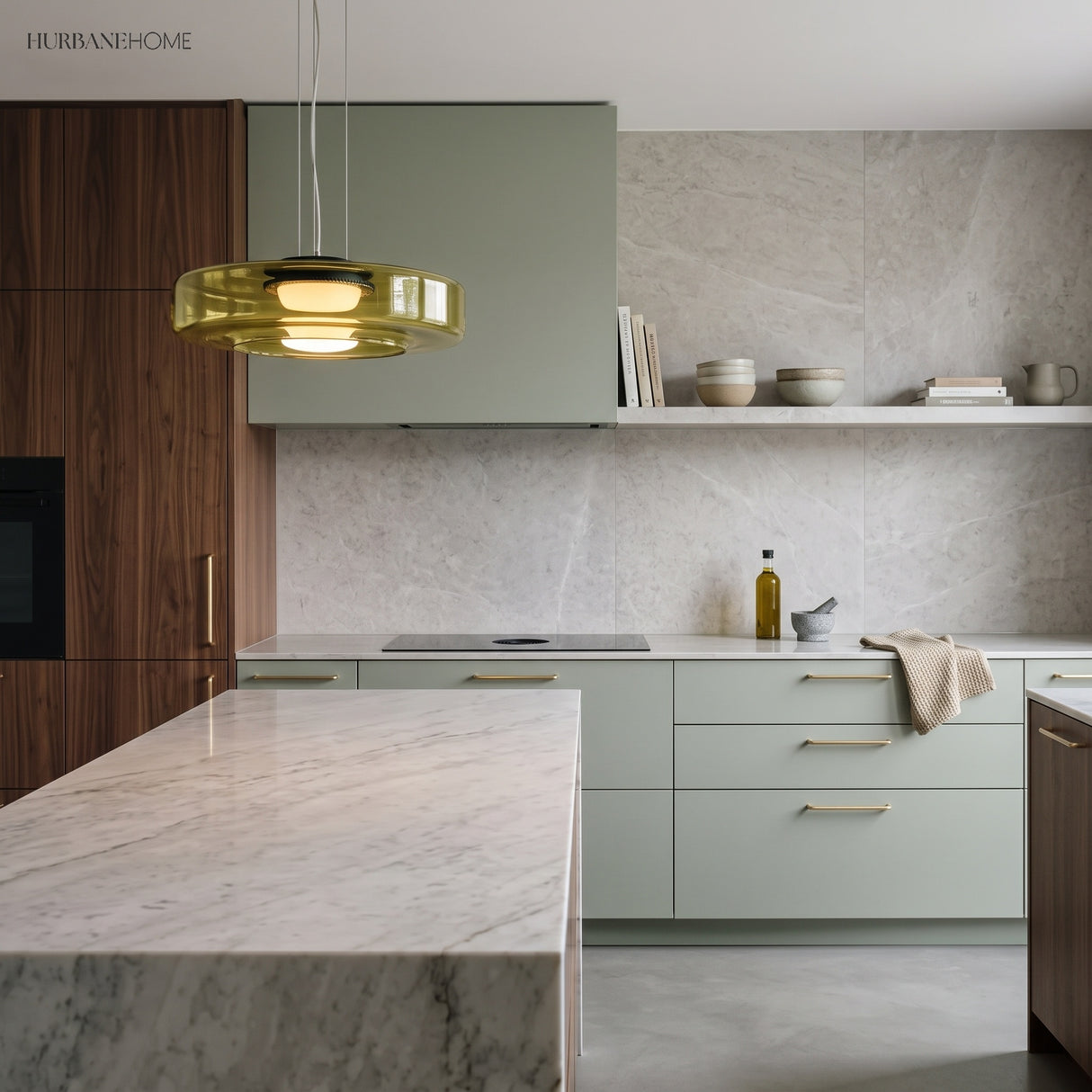 Amber glass disc pendant light in a modern kitchen with green cabinetry