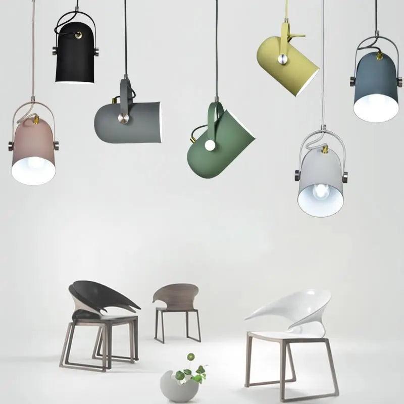 Seven pendant colours shown hanging together above modern chairs