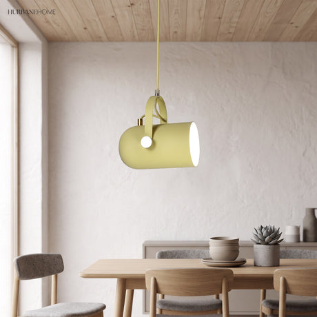 Yellow angled pendant lit above a wooden dining table and chairs
