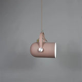 Pink spot pendant tilted downward on a pale cord