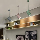 Row of coloured spot pendants above a long wooden shelf unit
