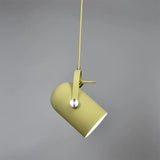 Yellow spot pendant on a yellow cord against a grey background