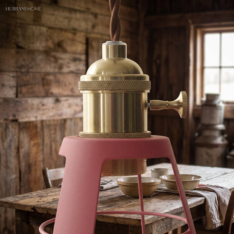 Close up of the brass socket above a pink stool in a barn kitchen